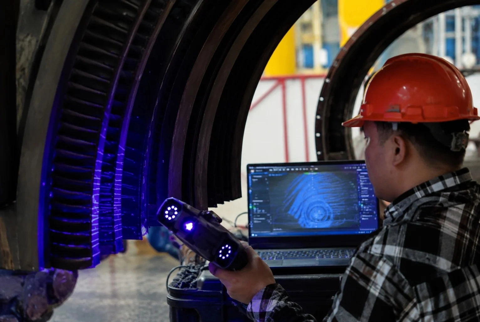 Technician performing 3D scanning inspection on turbine component