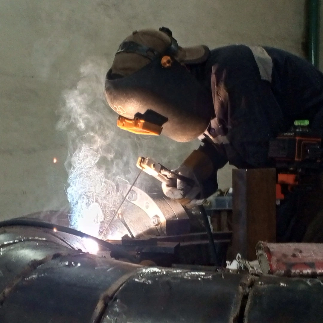 JPE welder on heavy industrial pipe in fabrication shop